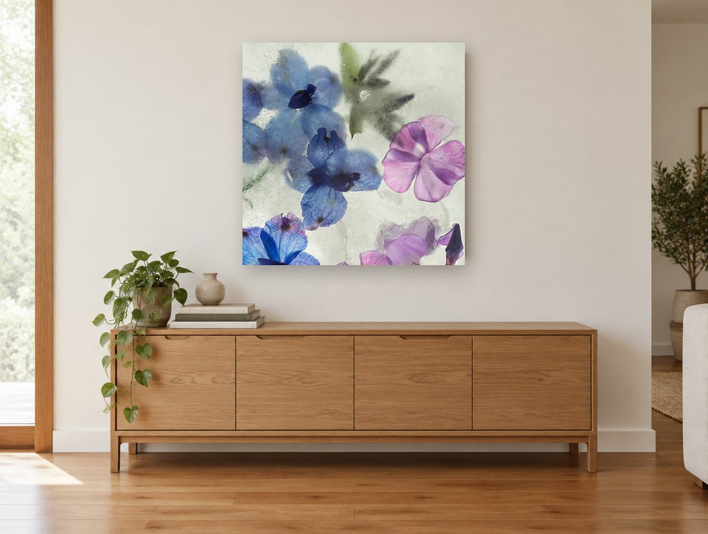 Blue Blooms in Ice floral canvas print on the wall of a living room above a sideboard