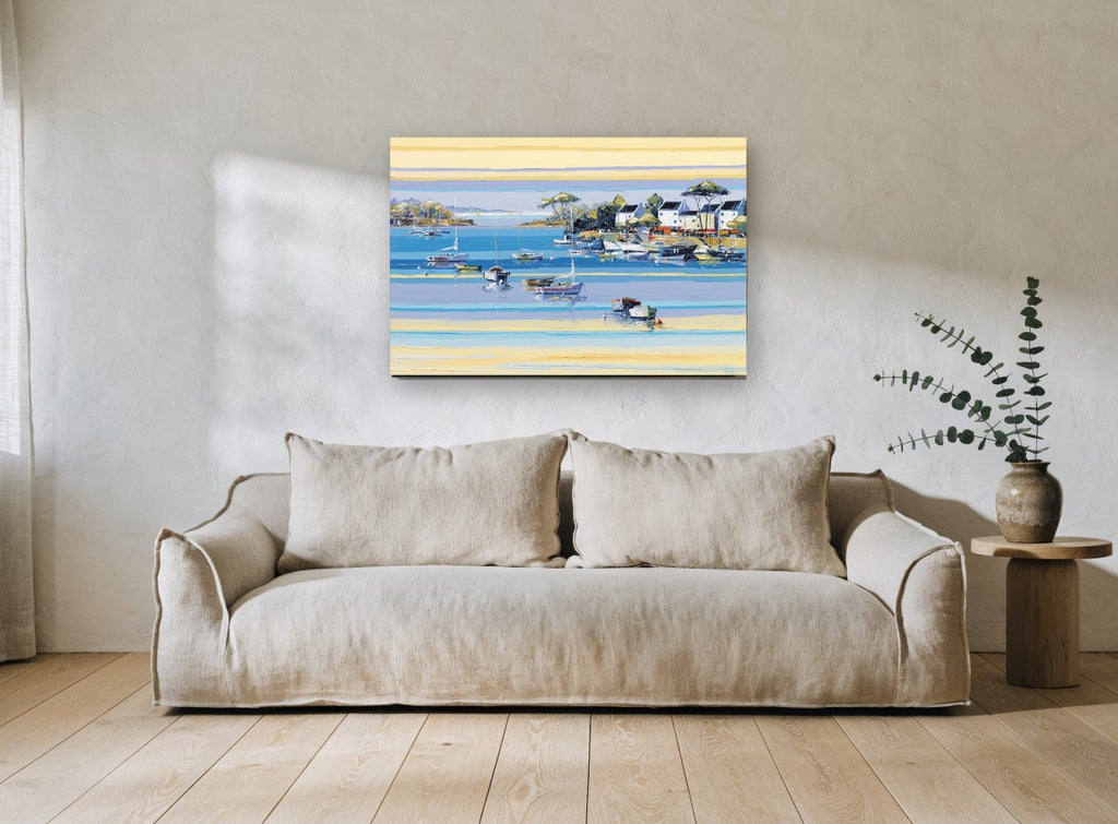 Sunlit Mooring Bay coastal canvas print on the wall of a living room