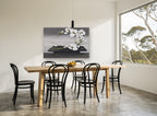 Orchid Arc on Black Tray floral canvas print on the wall of a dining room