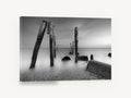 Silent Pilings at Dusk, weathered pilings black and white seascape, coastal canvas wall art print ready to hang