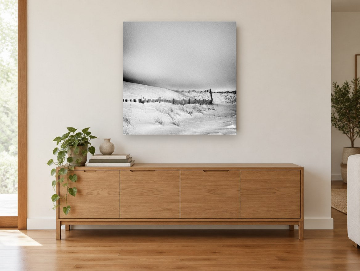 Snowbound Dune Fence coastal canvas print on the wall of a living room above a sideboard