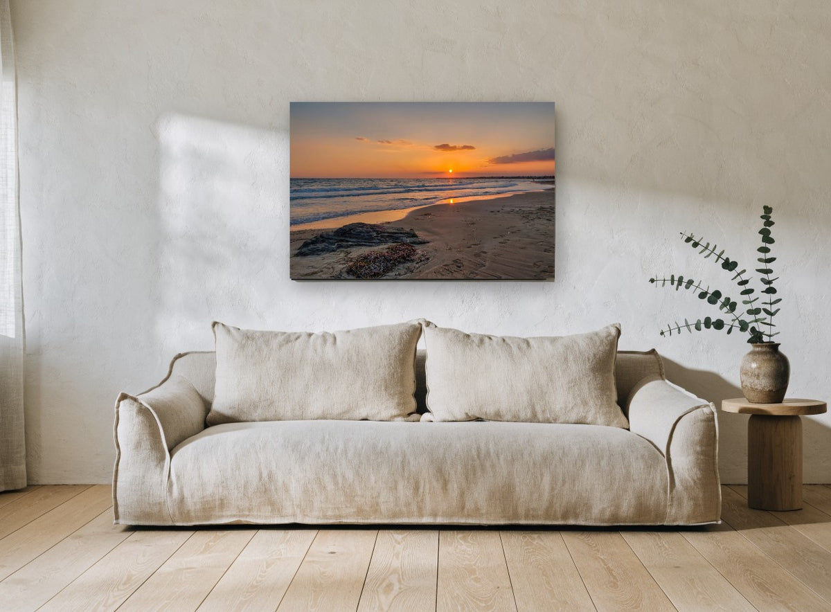 Footprints at Sunset Shore coastal canvas print on the wall of a living room