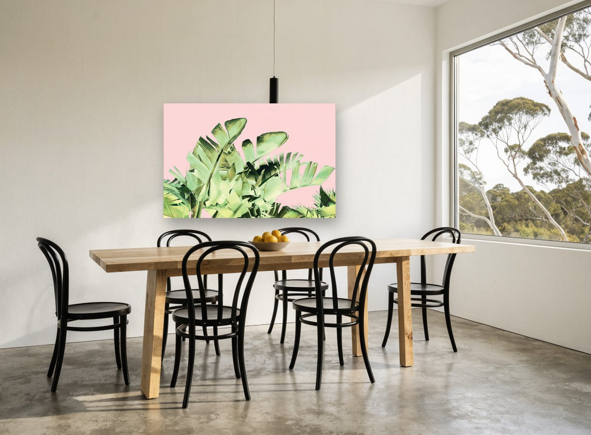 Blush Banana Fronds floral canvas print on the wall of a dining room