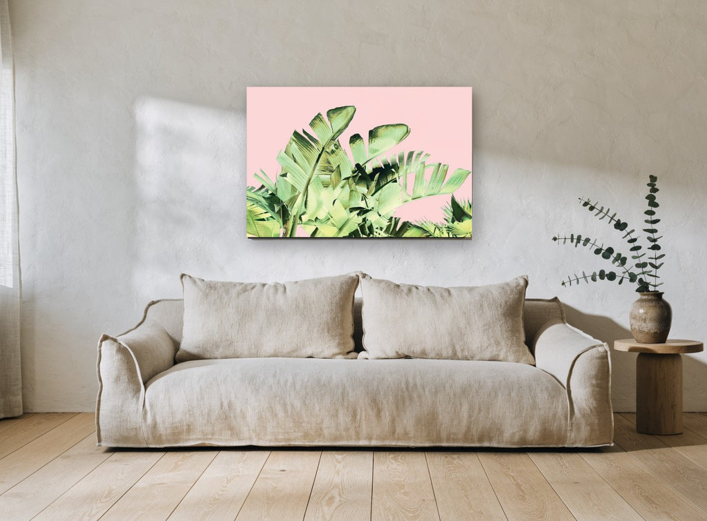 Blush Banana Fronds floral canvas print on the wall of a living room