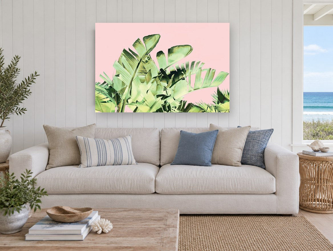Blush Banana Fronds floral canvas print on the wall of a beach house living room