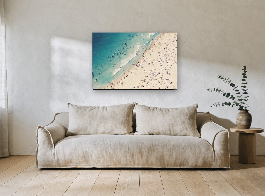 Crowded Summer Shore coastal canvas print on the wall of a living room
