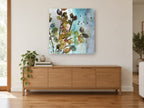 Teal Mist Branches floral canvas print on the wall of a living room above a sideboard