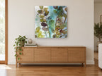 Teal Mist Leaf Stems floral canvas print on the wall of a living room above a sideboard