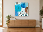Blue Bloom Cluster floral canvas print on the wall of a living room above a sideboard