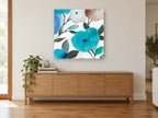 Aqua Bloom Drift floral canvas print on the wall of a living room above a sideboard