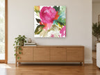 Magenta Bloom Wash floral canvas print on the wall of a living room above a sideboard