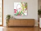 Tropical Fronds Bloom floral canvas print on the wall of a living room above a sideboard