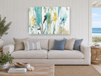 Teal Meadow Wash floral canvas print on the wall of a beach house living room