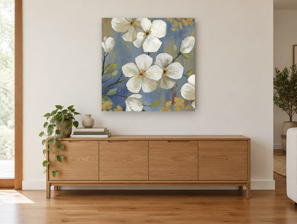 White Blossoms on Blue floral canvas print on the wall of a living room above a sideboard