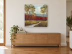 Crimson Grove Meadow floral canvas print on the wall of a living room above a sideboard