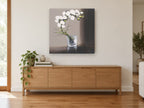 White Orchid in Glass floral canvas print on the wall of a living room above a sideboard