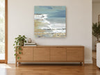 Misty Shore Surf coastal canvas print on the wall of a living room above a sideboard
