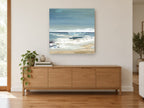 Quiet Shore Break coastal canvas print on the wall of a living room above a sideboard