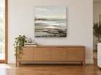 Misty Shoreline Strata coastal canvas print on the wall of a living room above a sideboard