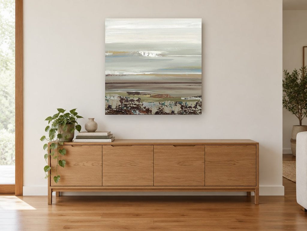 Quiet Shoreline Bands coastal canvas print on the wall of a living room above a sideboard