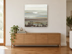 Quiet Shoreline Bands coastal canvas print on the wall of a living room above a sideboard