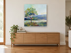 Lone Tree Lakeside landscape canvas print on the wall of a living room above a sideboard
