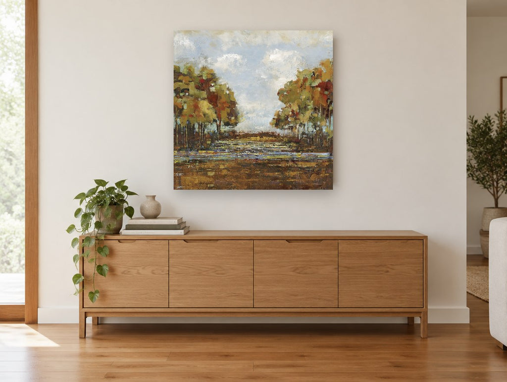 Autumn Creek Clearing landscape canvas print on the wall of a living room above a sideboard
