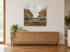 Autumn Creek Clearing landscape canvas print on the wall of a living room above a sideboard
