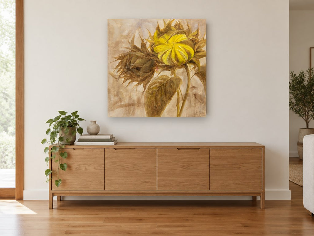 Turned Sunflower Bud floral canvas print on the wall of a living room above a sideboard