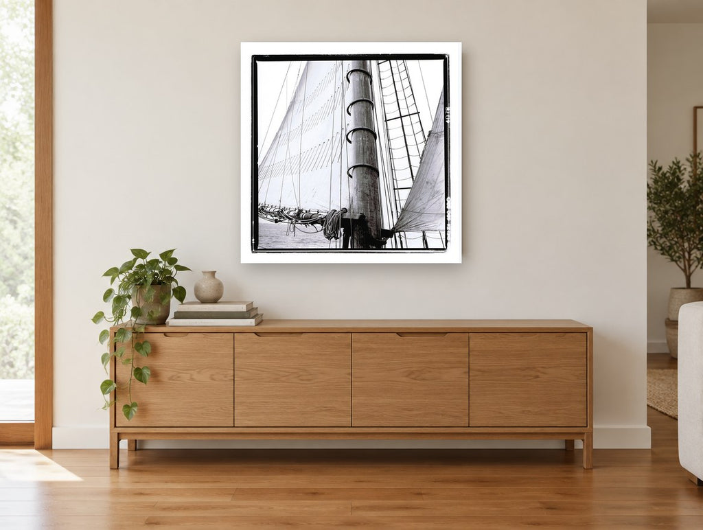 Mast and Canvas coastal canvas print on the wall of a living room above a sideboard