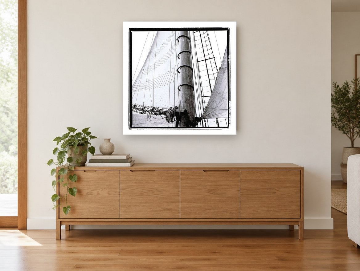 Mast and Canvas coastal canvas print on the wall of a living room above a sideboard