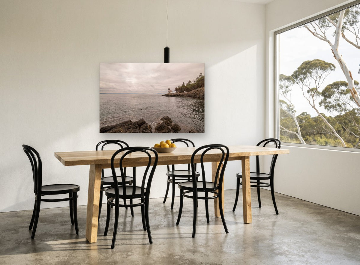 Quiet Point Light coastal canvas print on the wall of a dining room