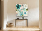 Teal Glass Blossoms floral canvas print on the wall of a hallway