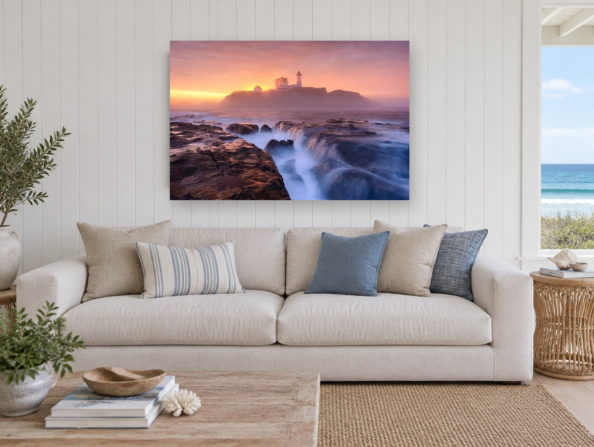 Lighthouse Dawn Tide coastal canvas print on the wall of a beach house living room