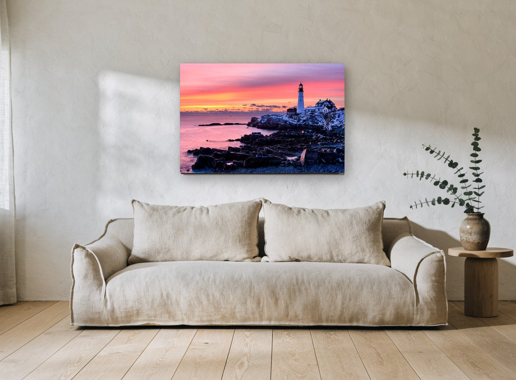 Lighthouse Dawn Glow coastal canvas print on the wall of a living room