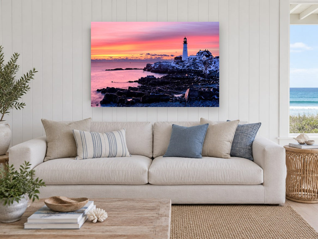 Lighthouse Dawn Glow coastal canvas print on the wall of a beach house living room