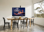 Moonlit Lighthouse Christmas landscape canvas print on the wall of a dining room