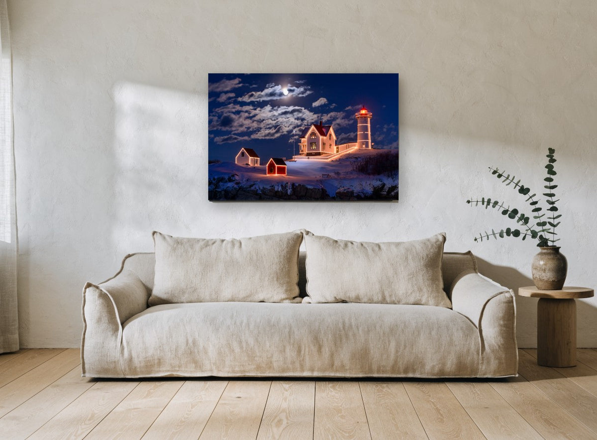 Moonlit Lighthouse Christmas landscape canvas print on the wall of a living room