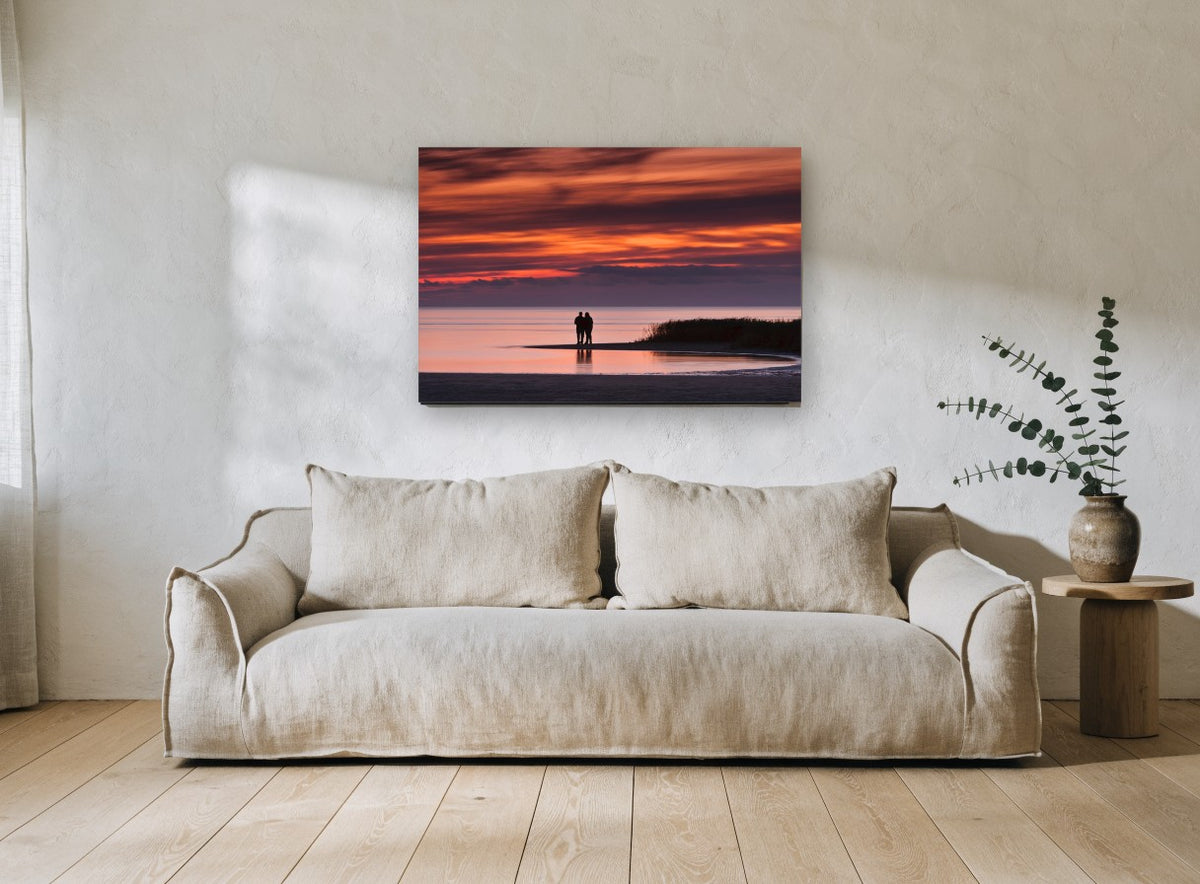 Couple at Dusk Shore coastal canvas print on the wall of a living room