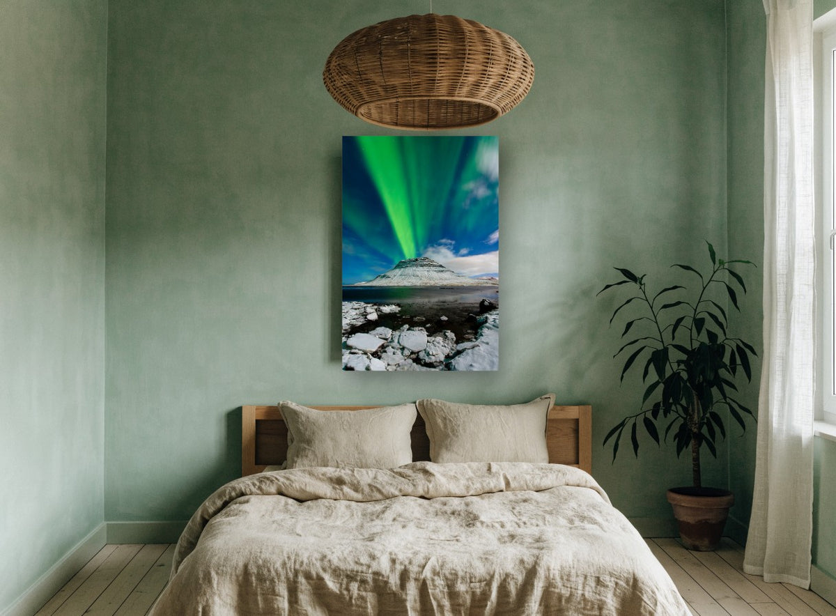 Green Aurora Over Snowy Peak coastal canvas print on the wall of a bedroom