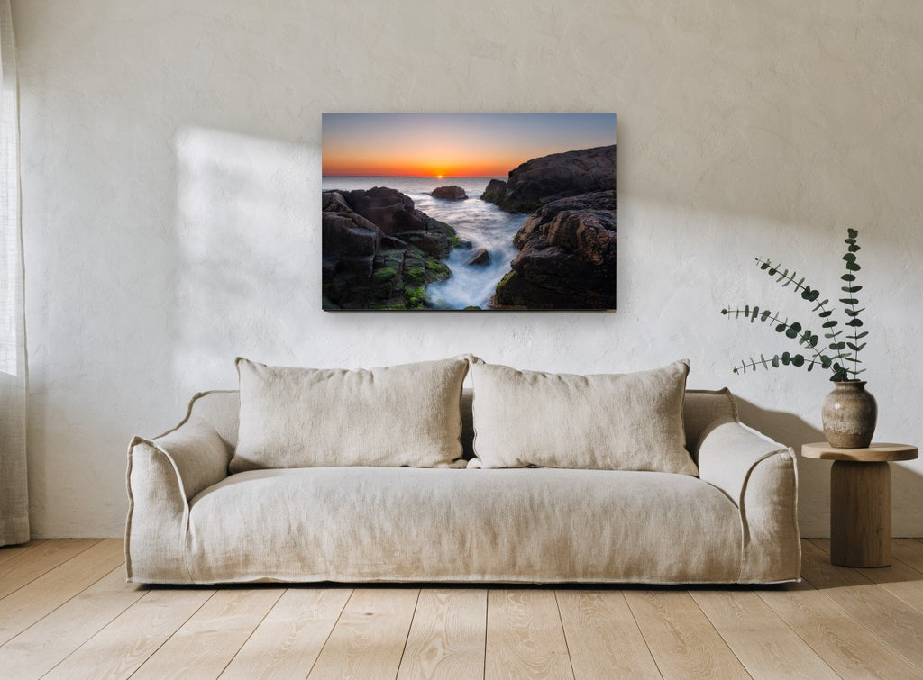Sunrise Rock Channel coastal canvas print on the wall of a living room