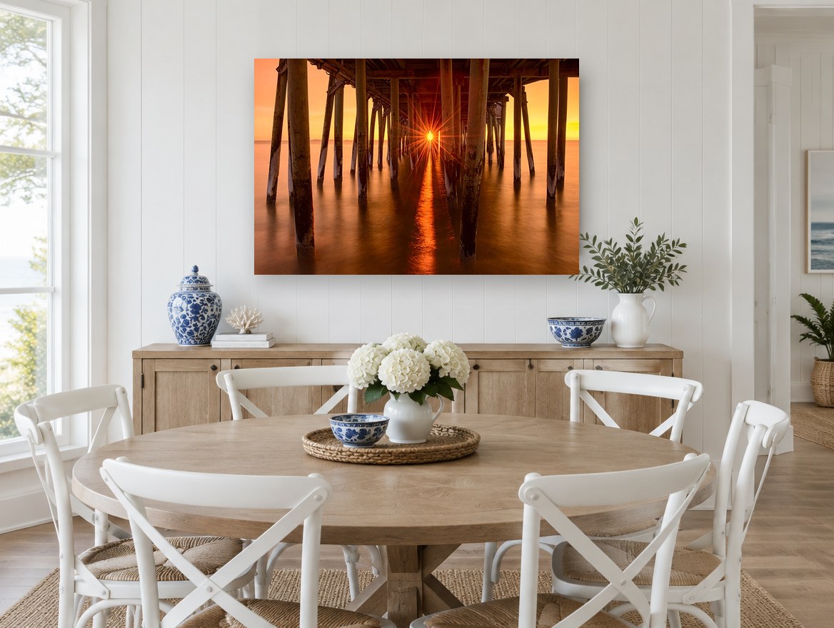 Sunburst Beneath the Pier coastal canvas print on the wall of a Hamptons dining room