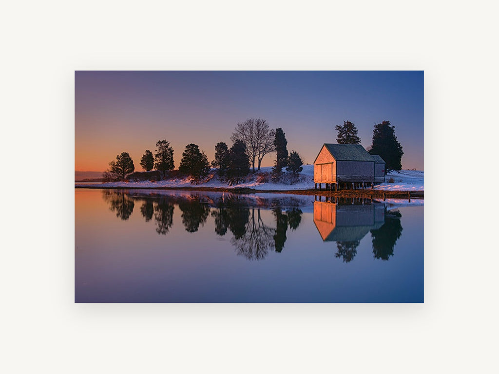 Dusk Boathouse Reflection, snowy boathouse lake reflection photograph, landscape canvas wall art print, front view