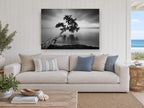 Leaning Tree Stillness coastal canvas print on the wall of a beach house living room