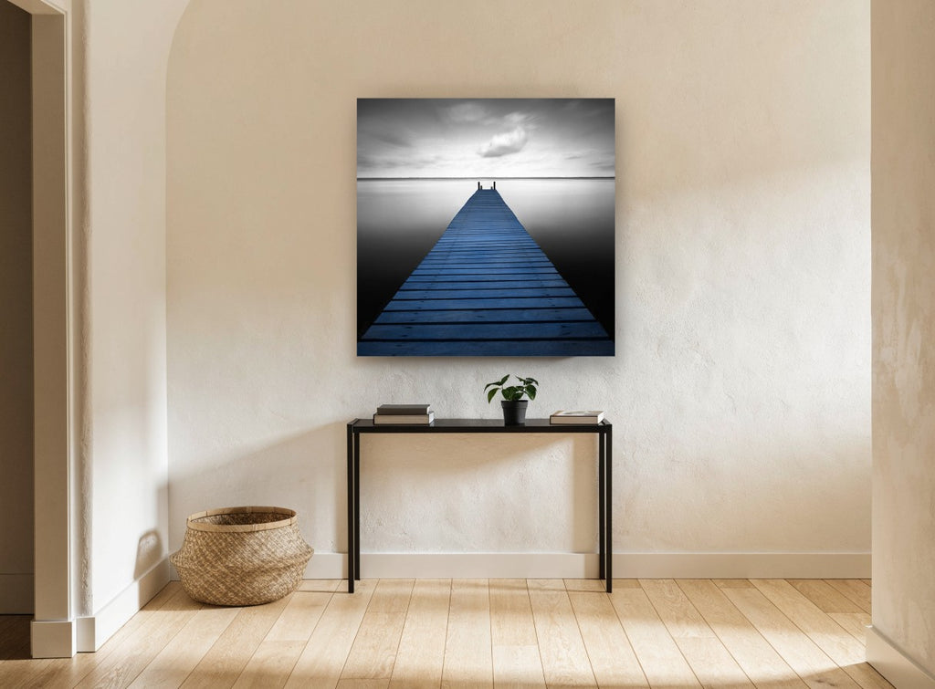 Blue Jetty Stillness coastal canvas print on the wall of a hallway