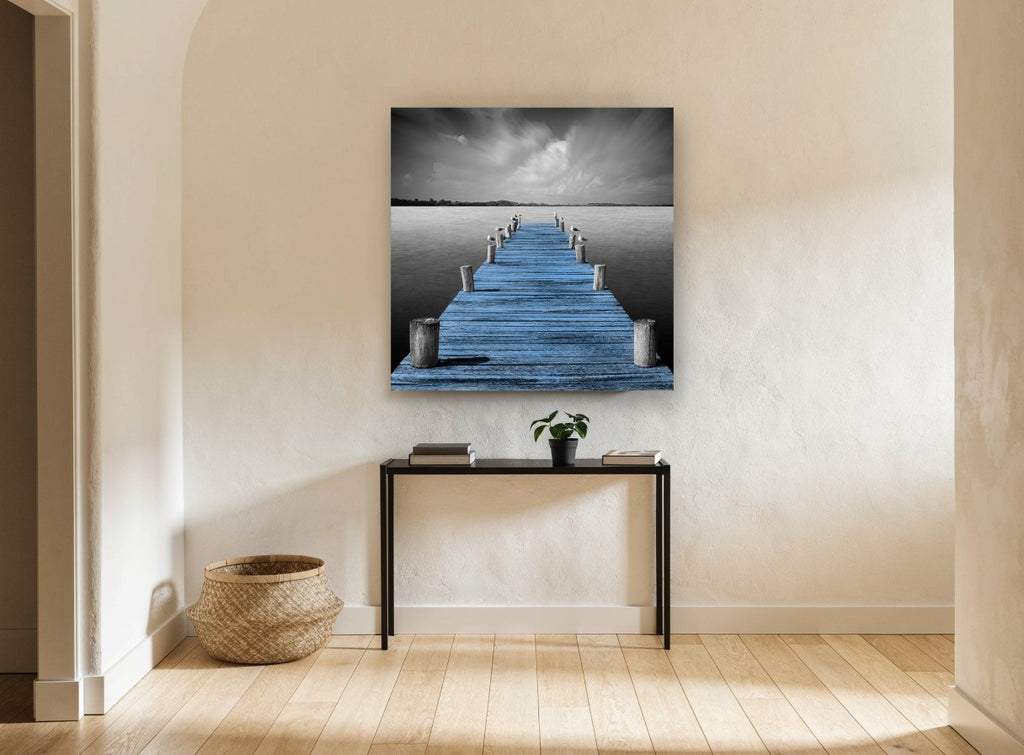 Blue Jetty Stillness coastal canvas print on the wall of a hallway