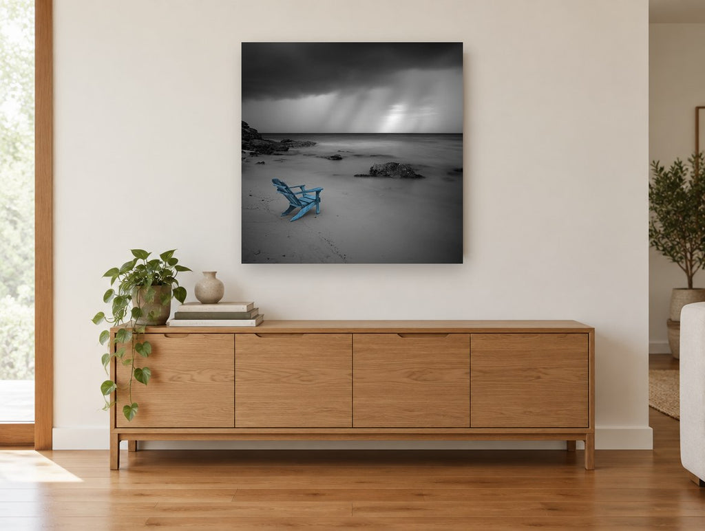 Blue Chair Storm Beach coastal canvas print on the wall of a living room above a sideboard