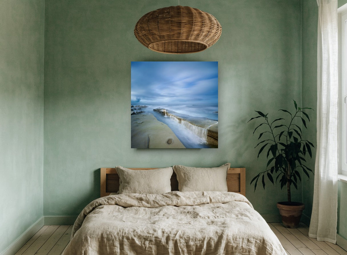 Misty Rock Channel coastal canvas print on the wall of a bedroom