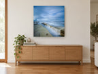 Misty Rock Channel coastal canvas print on the wall of a living room above a sideboard