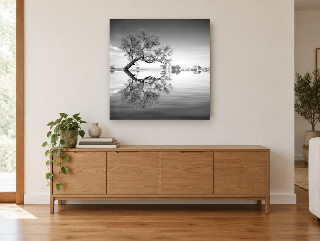 Leaning Tree Mirror landscape canvas print on the wall of a living room above a sideboard